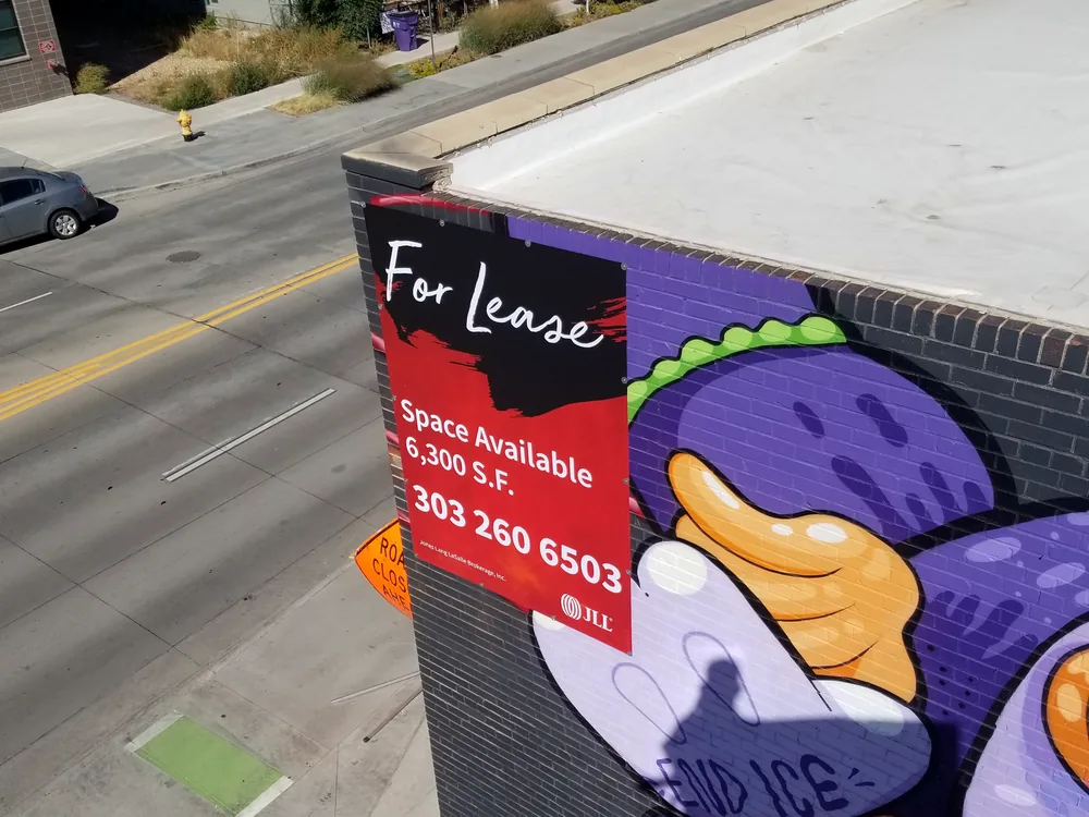 Large vertical commercial banner mounted high on a building