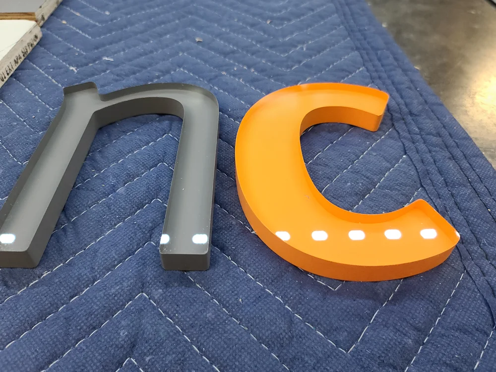 Mixed-color dimensional logo components fabricated by S2