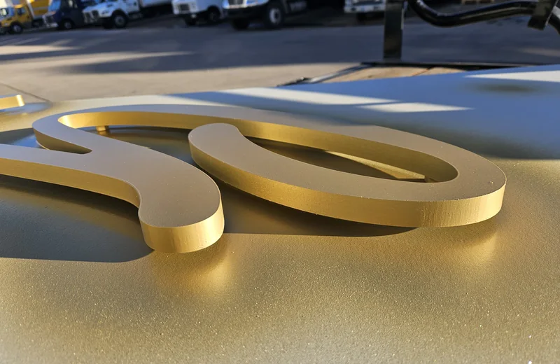 Golden Hour aluminum dimensional logo components fabricated by S2