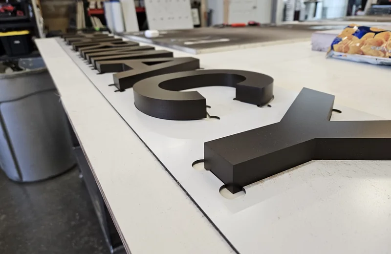Flat-cut dimensional letters in the S2 shop