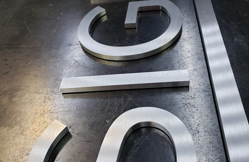 Brushed aluminum dimensional letters fabricated by S2