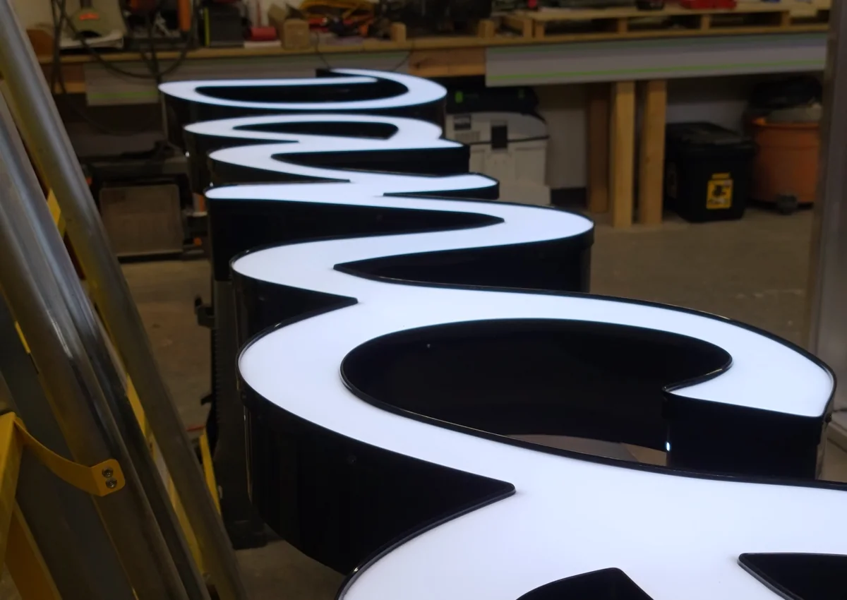 Front-lit channel letters illuminated and inspected during shop testing in Loveland, Colorado