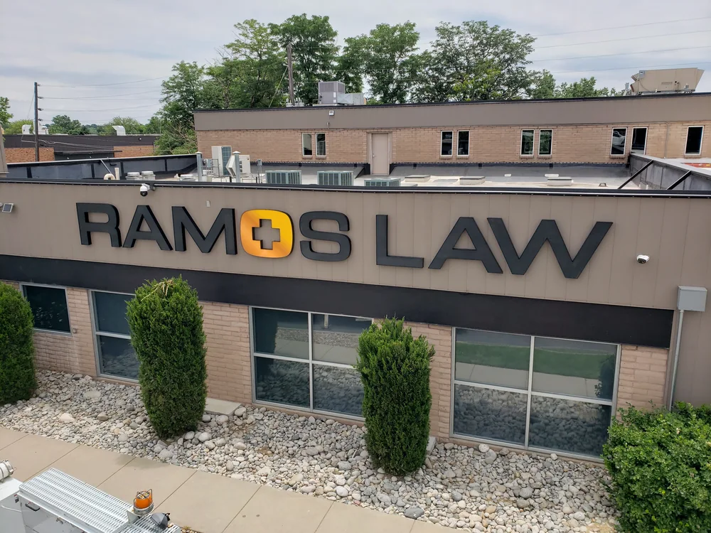 Ramos Law front-lit channel letters with black daytime faces and white nighttime illumination