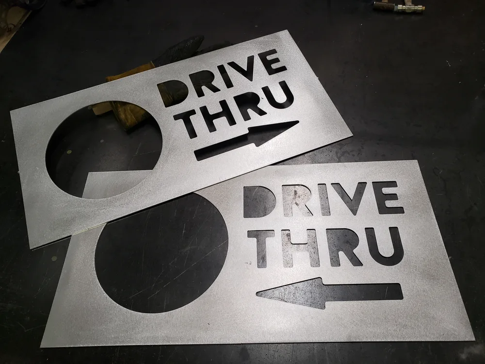 Cut aluminum sign components in the S2 shop
