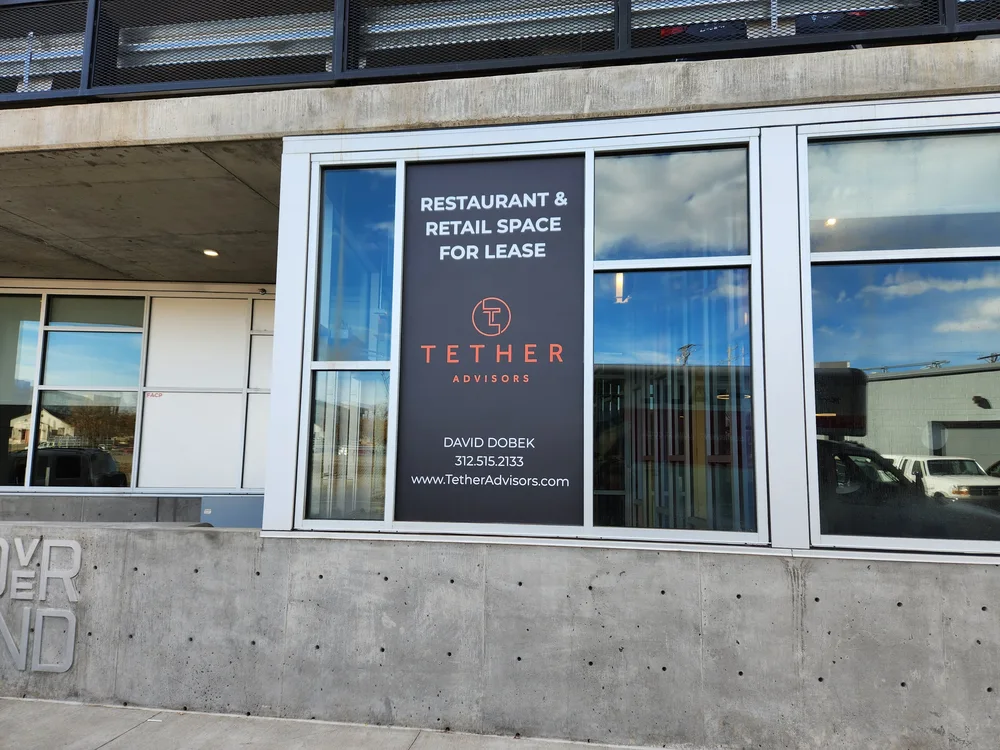 Commercial leasing graphics installed on storefront windows