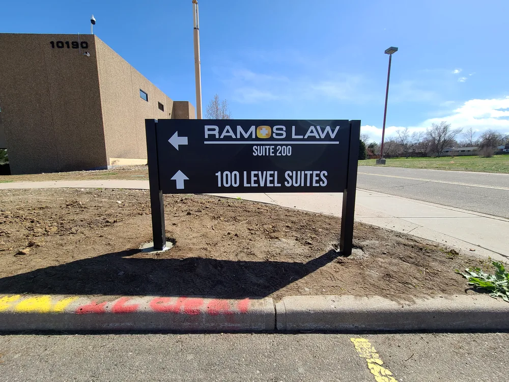 Office campus directional sign with arrows and suite destinations