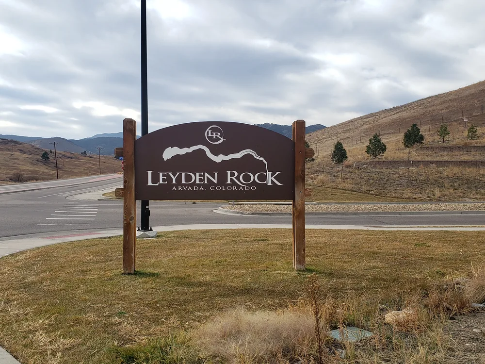 Property entry sign directing visitors into a development